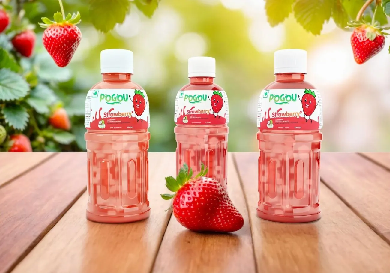 Three bottles of Pogou Strawberry juice on a wooden table with strawberries